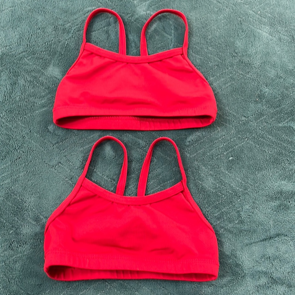 Two small red racer back sports bras/dance tops, size CS and CI